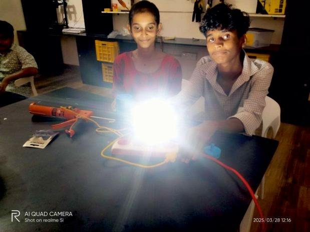 Students light up an LED bulb they assembled